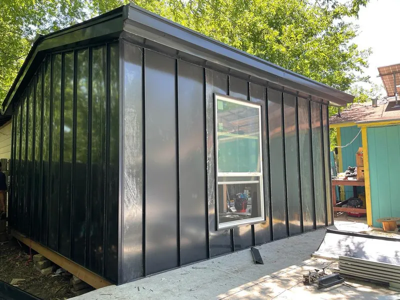 Black standing seam metal wall panels for Roof Inspection in Sweden